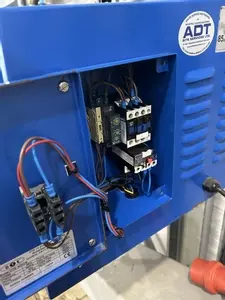 Replacement electrical contactor and overload fitted inside the control panel of a Nilfisk DTE wall-mounted pressure washer.